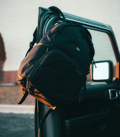 Packed bag on a Jeep door at golden hour
